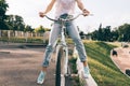 Cropped image of a woman in jeans and a T-shirt sitting on a cit Royalty Free Stock Photo