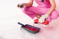 cropped image of woman in protective gloves and working overall pouring liquid from bottle into