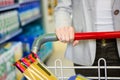 Cropped image of woman pushing trolley in aisle Royalty Free Stock Photo