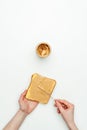 cropped image of woman putting peanut butter on bread