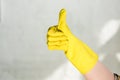 cropped image of woman in rubber glove showing thumb up while cleaning