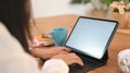 Cropped image of a woman`s hands is using a white blank screen computer tablet. Royalty Free Stock Photo