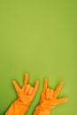 cropped image of woman showing rock signs in rubber protective gloves Royalty Free Stock Photo