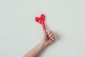 cropped image of woman showing thumb up with heart shaped balloon on finger on white, valentines
