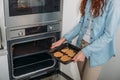 cropped image of woman taking homemade biscuits Royalty Free Stock Photo