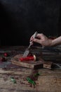 cropped image of woman taking piece of strawberry pie