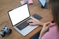 Cropped image of a woman is using a white blank screen computer laptop. Royalty Free Stock Photo