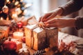 Cropped image of woman wrapping Christmas gift box in craft paper. Selective focus