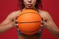 Cropped image of young african american sports fitness basketball player woman in sportswear working out isolated on red Royalty Free Stock Photo