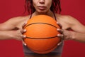 Cropped image of young african american sports fitness basketball player woman in sportswear working out isolated on red Royalty Free Stock Photo