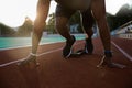 Cropped image of a young african male sprinter getting ready