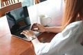 Cropped image of young business woman working with laptop in workplace of office Royalty Free Stock Photo