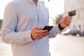 Cropped image of young casual man using mobile phone Royalty Free Stock Photo