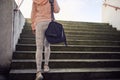 Cropped image of young female walking upstairs carrying sport bag on her shoulder Royalty Free Stock Photo