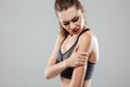 Cropped image of young fitness woman having arm pain