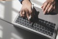 Cropped image of a young man working on his laptop in a coffee shop, rear view of business man hands busy using laptop at office Royalty Free Stock Photo