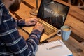 Cropped image of a young man working on his laptop in a coffee shop, rear view of business man hands busy using laptop Royalty Free Stock Photo