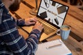 Cropped image of a young man working on his laptop in a coffee shop, rear view of business man hands busy using laptop