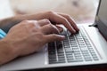 Man`s hands typing on laptop notebook keyboard at home. Man browsing information on internet. Freelance blogging, it