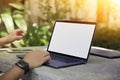 Cropped image of a young man working on his laptop in a garden, rear view of business man hands busy using laptop at office desk, Royalty Free Stock Photo