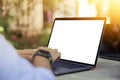 Cropped image of a young man working on his laptop in a garden, rear view of business man hands busy using laptop at office desk, Royalty Free Stock Photo