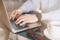 Cropped image of a young man working on his laptop, man hands busy using laptop at office desk, young male student typing on Royalty Free Stock Photo