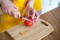 Cropped image of Young Mother Helping Daughter to cut tomato Royalty Free Stock Photo