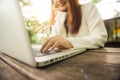 Cropped image of young woman using laptop at coffee shop. Close up portrait asian woman working on laptop computer. Royalty Free Stock Photo