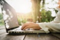 Cropped image of young woman using laptop at coffee shop. Close up portrait asian woman working on laptop computer. Royalty Free Stock Photo