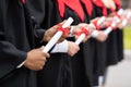 Cropped of international group of graduates holding diplomas