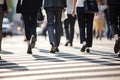 Cropped legs busy city, business people on zebra crossing street, day time