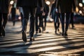 Cropped legs busy city, business people on zebra crossing street, night time