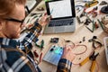 Technician pointing on technical scheme on laptop