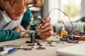 Cropped man technician or engineer soldering chip Royalty Free Stock Photo