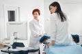 Cropped panorama of gynecologist examining a patient who is sitting in a gynecological chair. Female health concept. Royalty Free Stock Photo