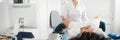 Cropped panorama of gynecologist examining a patient who is sitting in a gynecological chair. Female health concept. Royalty Free Stock Photo