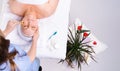 Cropped photo of a beautician, massage the face of a senior woman using a roller wooden massager. Beauty salon, scented Royalty Free Stock Photo