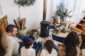 Cropped photo of big family wearing warm woolen socks resting by fireplace