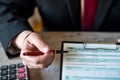 cropped photo of business man in jacket filling out tax forms and making calculations at desk. Royalty Free Stock Photo