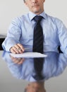 Cropped photo of businessman sitting at table in office