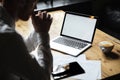 Cropped photo of businessman sitting at wooden table, focus on l