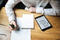 Cropped photo of businessman in white shirt working on wooden ta Royalty Free Stock Photo