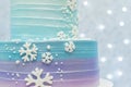 Two tier cake on blue background with unfocused lights. Royalty Free Stock Photo