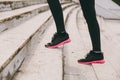 Cropped photo close up of female legs in sportswear, black and pink woman sneakers doing sport exercises, climbing on Royalty Free Stock Photo