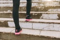 Cropped photo close up of female legs in sportswear, black and pink woman sneakers doing sport exercises, climbing on Royalty Free Stock Photo