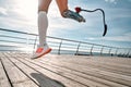 Never give up. Cropped photo of a disabled woman with a prosthetic leg in sportswear jumping on the bridge Royalty Free Stock Photo