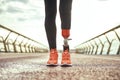 Cropped photo of disabled woman with prosthetic leg in sportswear standing on the bridge Royalty Free Stock Photo