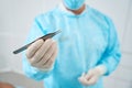 Cropped photo of doctor holds in his hand tweezers and a pellet Royalty Free Stock Photo