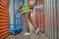 Male worker pushing an empty warehouse trolley