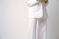 Cropped photo, gorgeous female in white suit isolated over grey background